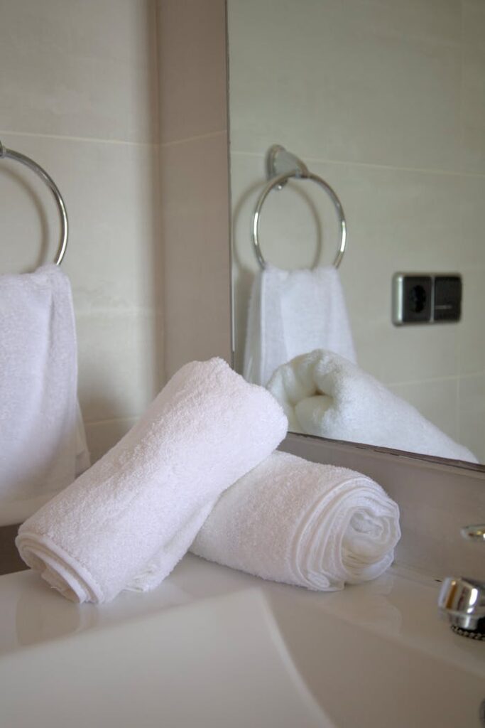 Pristine white towels neatly arranged in a stylish bathroom setting.